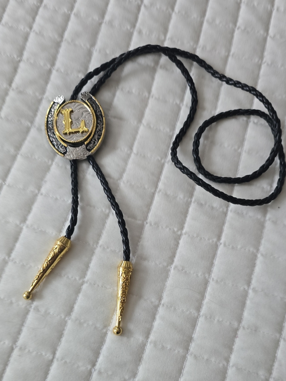 Black Braided Leather Bolo Tie with Gold Horseshoe Emblem